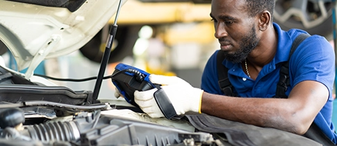Technician using a diagnostic scanner